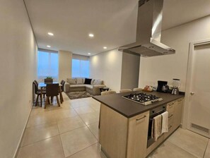 Enjoy a combined living and dining area with a kitchenette, perfect for preparing meals and relaxing.