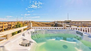 A hot tub with a wooden deck and a view of the beach. - A Shore Thing - Oceanfront - Hot Tub -Pet Friendly (Carolina Beach)
