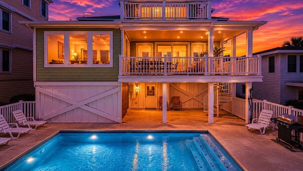 A two-story house with a swimming pool, a balcony, and a covered patio area. - No Cleaning Fee - 6BR Oceanfront - Oceanfront - Pool (Carolina Beach)
