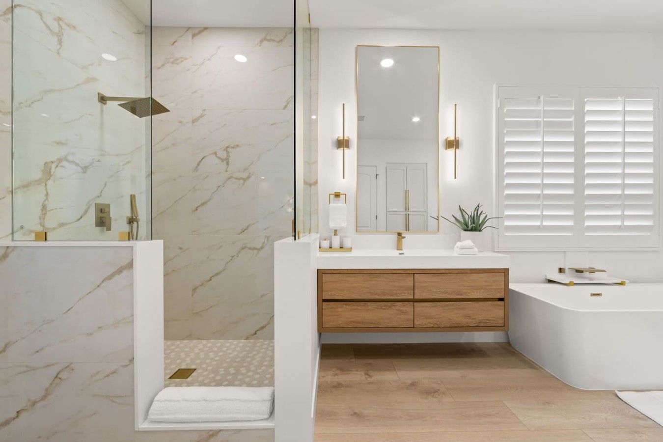 A modern bathroom with a glass-enclosed shower, a wooden vanity, and a large mirror.