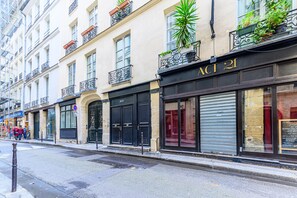 A street view of a building with a storefront labeled "ACT 21".