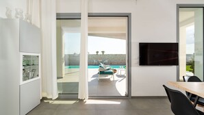 A modern kitchen with a glass door leading to a pool area. - Stunning private villa for 7 people with A/C, WIFI, private pool, TV, patio and panoramic view (Noto)