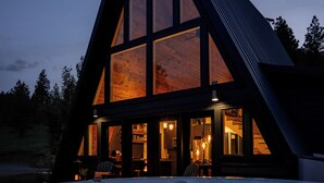 A large, modern house with a hot tub in front. - Secluded Montana A-Frame with Hot Tub and Views (Jefferson City)