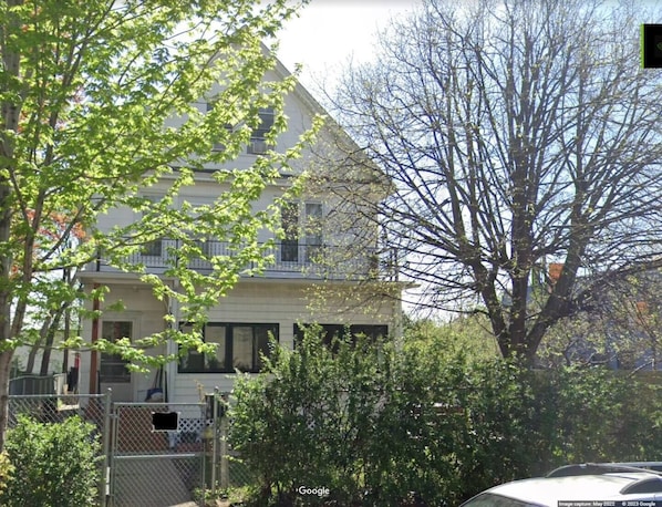 A two-story building with a balcony on the second floor.