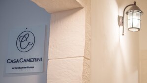 A sign for "Casa Camerini" with a logo and text indicating its location in the heart of Puglia. - Casa Camerini in Villanova (Ostuni)