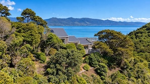 A coastal property with a view of the sea and mountains.
