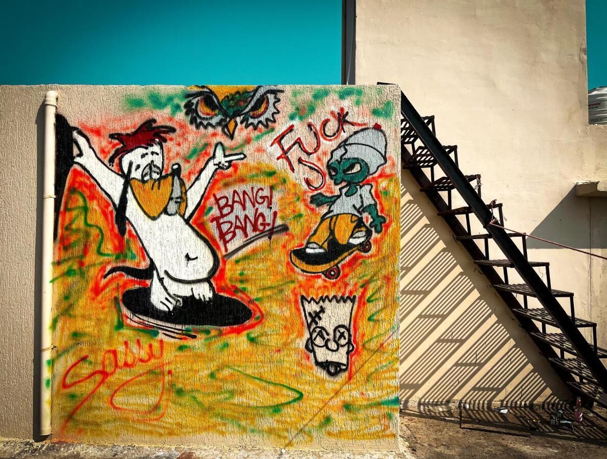 A wall with graffiti featuring cartoon characters and the word "Bang Bang!".