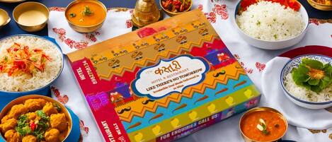 A variety of Indian dishes and a colorful brochure on a table.