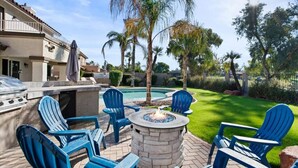A patio with outdoor seating, a fire pit, and a swimming pool. - 6th Tee Luxury | Pool & Fire Pit (Chandler)