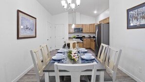 A modern kitchen with wooden cabinets, a stainless steel refrigerator, and a microwave. - Brand New Duplex Close to Water Park, Downtown & Airport- Pet Friendly. (Montrose)