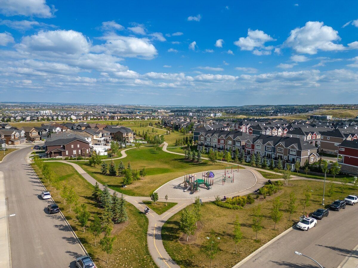A residential area with houses, a playground, and a road.