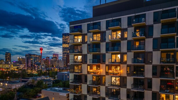 A modern high-rise building with multiple balconies and large windows, likely part of a hotel or apartment complex. - Howdy! 1BR Western Theme w Rooftop Patio & AC (Calgary)