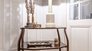 A corner table with a lamp, a decorative item, and a glass jar. - Mindful Enlightenment, by Veeve (Paris)