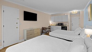 A hotel room with two beds, a TV, a kitchenette, and a dining area. - Exquisite Unit on the 1st Flr Resort View Room (Pawleys Island)