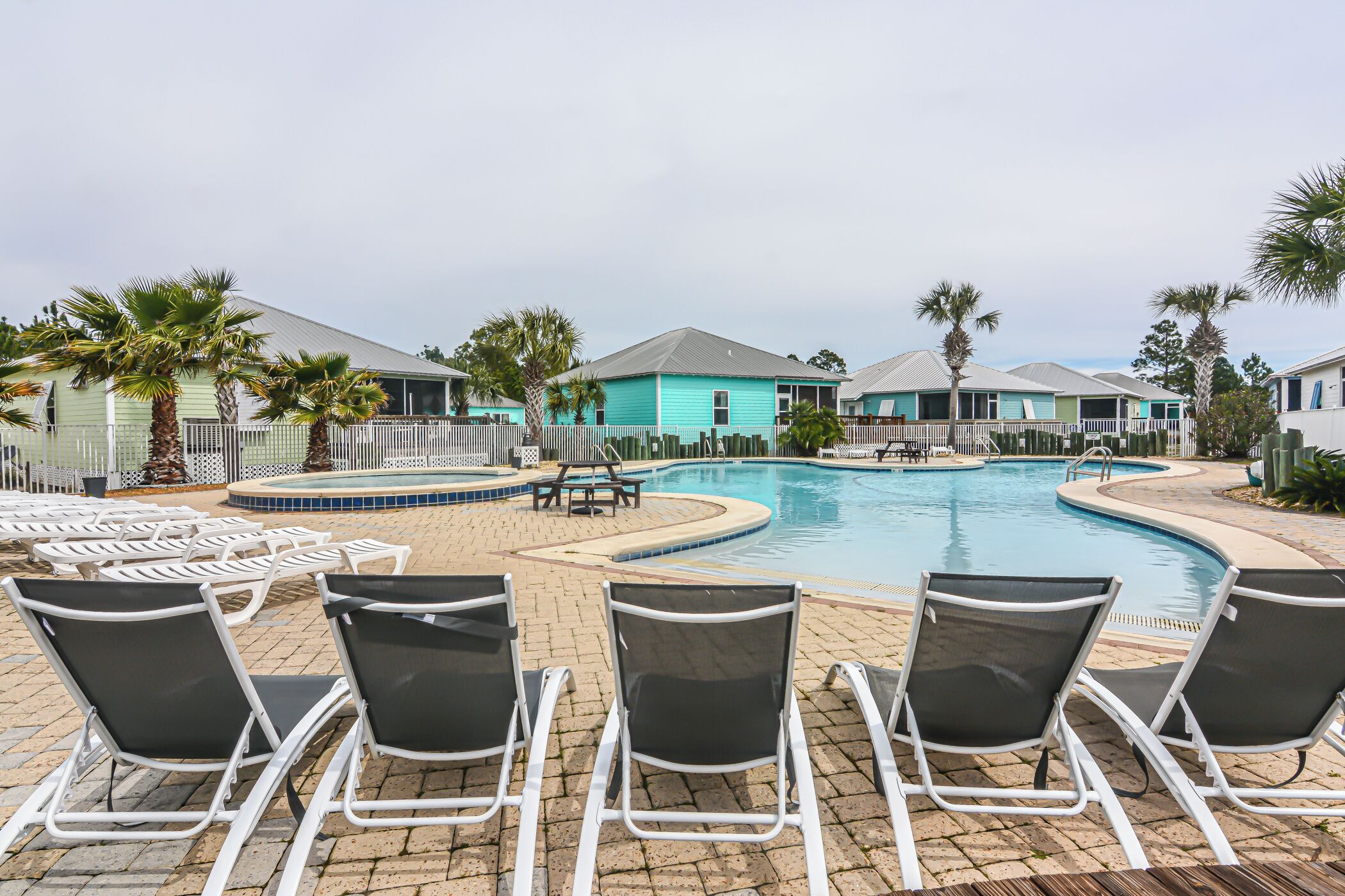 A pool area with lounge chairs and a small pool.
