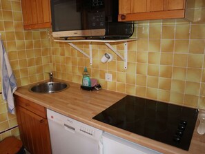 Kitchen features a microwave, dishwasher, induction cooktop, and oven.