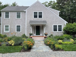 A two-story house with a front porch, a green door, and a number '59' on the front. - Perfectly private location w/deeded beach access! (Orleans)