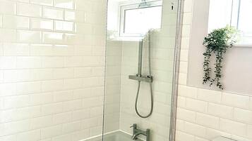 Combined shower/bathtub, deep-soaking bathtub, towels
