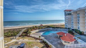 A beachfront hotel with a swimming pool, beach access, and a view of the ocean. - Oceanfront Condo with Pool View (North Topsail Beach)