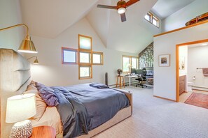 A bedroom with a bed, a desk, and a computer in the background. - Spacious Townhome Near Main St & Lake Dillon! (Frisco)