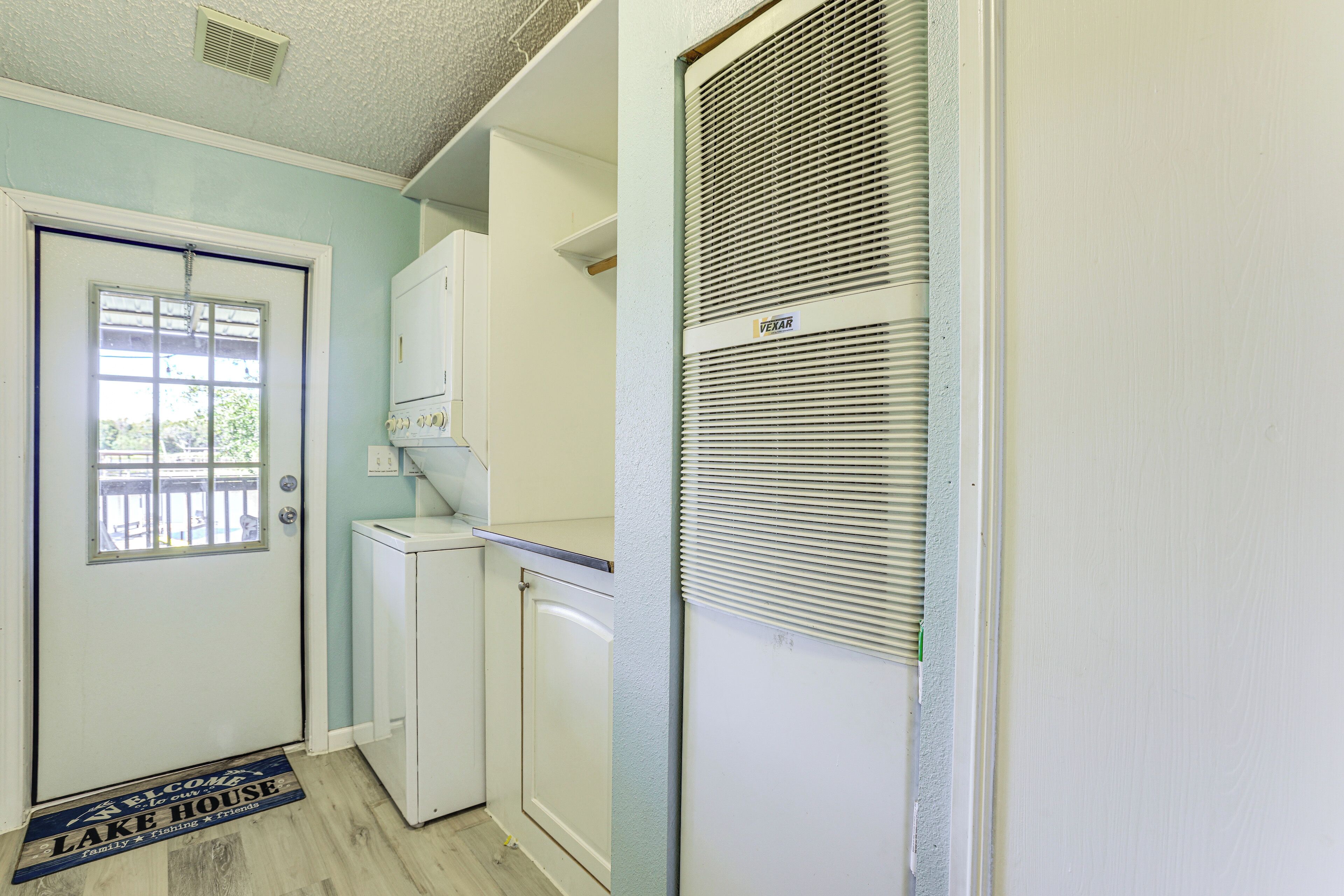 A compact kitchen with a refrigerator, a microwave, and a built-in oven.