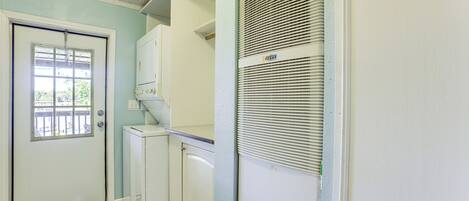 A compact kitchen with a refrigerator, a microwave, and a built-in oven.