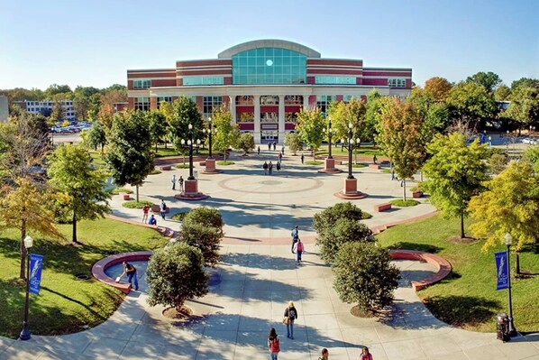 A large building with a central courtyard surrounded by trees and pathways.