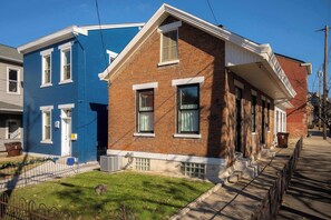 Een rij herenhuizen met een bakstenen gevel en een blauwe buitenzijde.