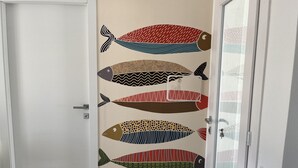 A door with a wall decal of stylized fish. - Villasimius Villa Mediterranean Sea... TOP!!! (Simius)