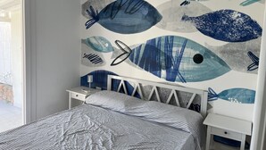 A bedroom with a bed, a nightstand, and a wall with fish mural. - Villasimius Villa Mediterranean Sea... TOP!!! (Simius)