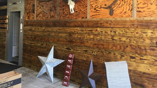 A rustic interior with wooden paneling, a star decoration, and a sign reading "OFFICE". - R/V spots on working horse farm $85 per night/$850 dollars per mo (Citra)