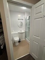 Shower, rainfall showerhead, hair dryer, towels