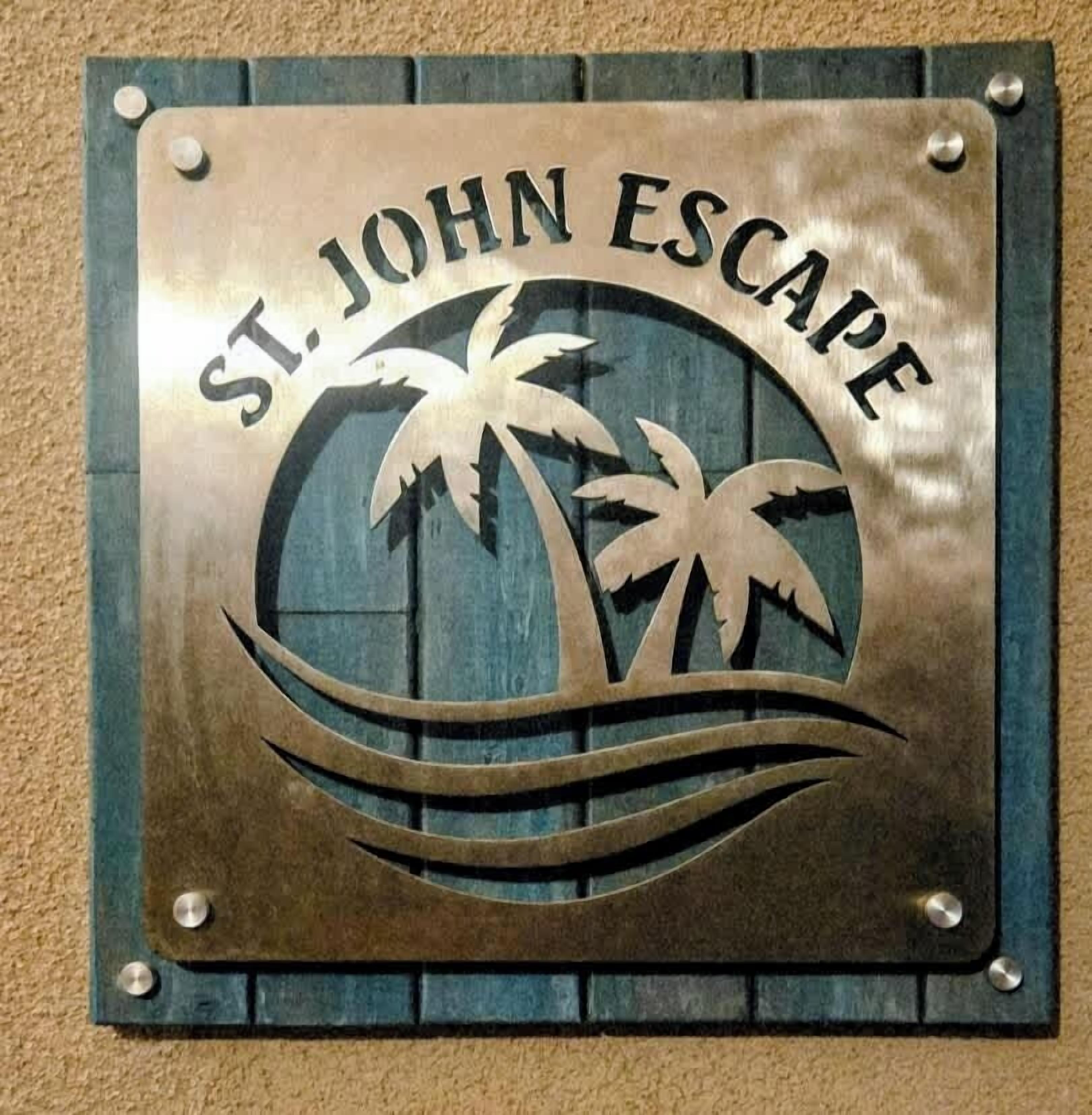 A plaque with the text "St. John Escape" and palm tree graphics.
