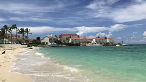 A beachfront hotel with multiple buildings, a sandy beach, and the ocean. - Delaporte Point Near waterpark Private Beach! (Nassau)