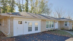 A two-story house with a garage, a driveway, and a lawn with scattered leaves. - 3 bed 2 bath with lovely outdoor space (Lebanon)