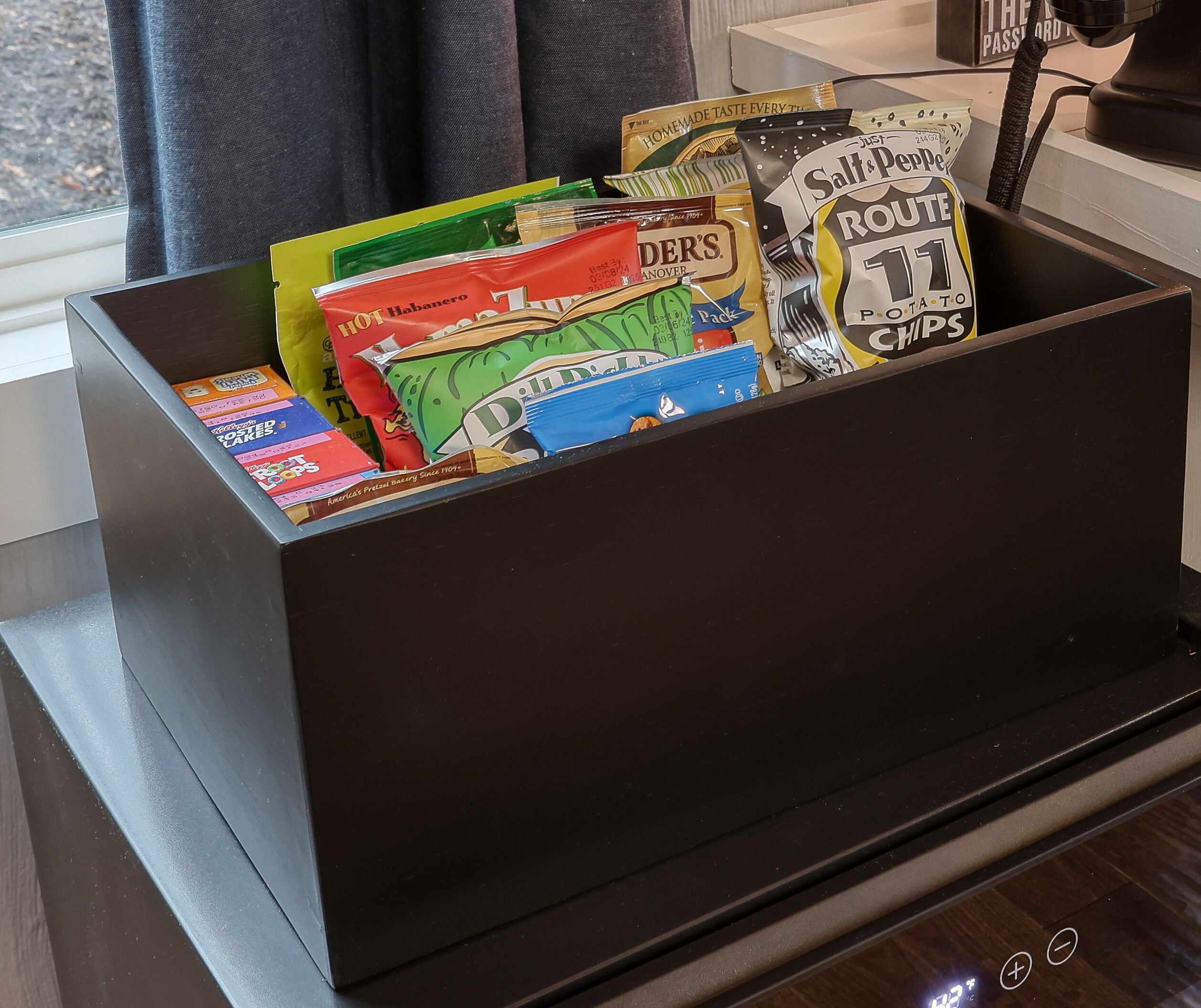 A storage box filled with various snack packets.