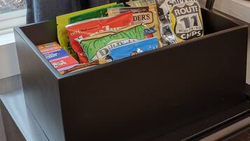 A storage box filled with various snack packets.