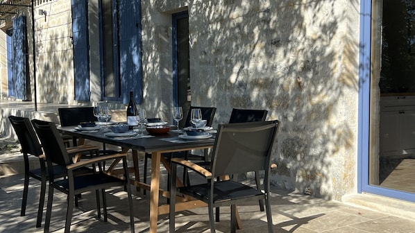 Enjoy al fresco dining with a view of the surrounding building, set amidst a beautifully appointed outdoor space.