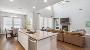 A spacious living area with a kitchen island, a sofa, and a fireplace.