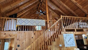 A wooden interior with a staircase, a ceiling fan, and a clock on the wall. - Cardinal Nest -Mountain views, babbling stream, fields to play in, privacy! (Blairsville)