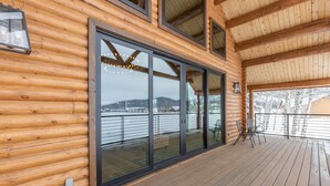 A wooden cabin with large windows and a deck. - Gorgeous Alpine Hollow on 3 acres - Hot Tub (Alpine)