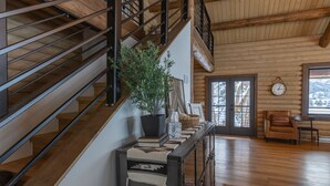 A wooden staircase with a potted plant, a bench, and a clock on the wall. - Gorgeous Alpine Hollow on 3 acres - Hot Tub (Alpine)