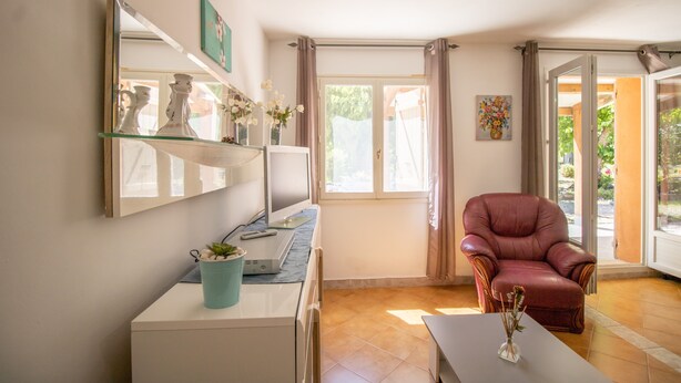 A room with a desk, chair, and a large window with curtains. - Holiday Home 'Isula Paradise' with Mountain View, Private Terrace (LINGUIZZETTA)