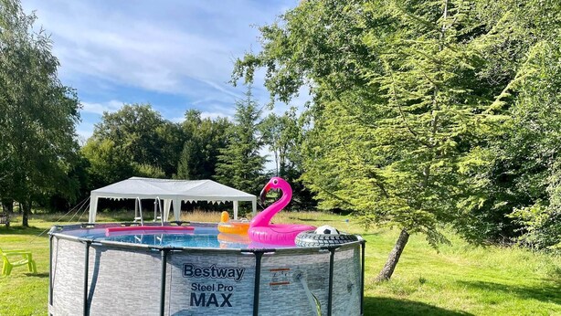 A backyard with a swimming pool, a tent, and a flamingo float. - Sunrise - A beautiful 2 bedroom Gite in the unspoiled countryside of the Cruese (CHENIERS)