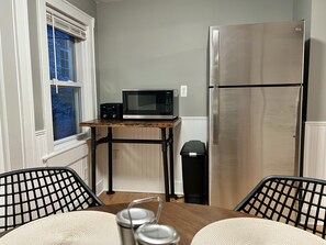 A compact kitchen with a microwave, refrigerator, and a trash bin. - Cozy Stay Near Capitol Theatre/Downtown — Very Walkable! (Port Chester)