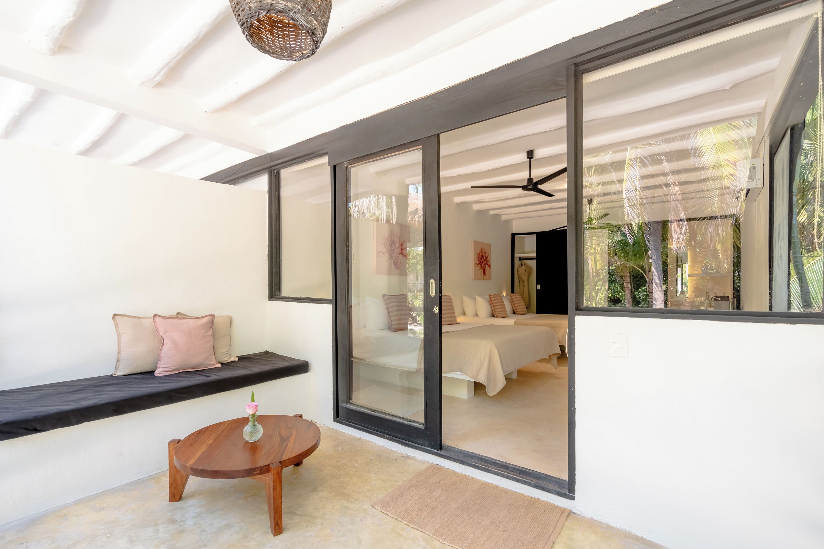 A modern bedroom with a large sliding glass door leading to a balcony.