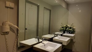 A bathroom with three sinks, a hairdryer, and a mirror. - Terminal 58 hostel at town (Phuket)