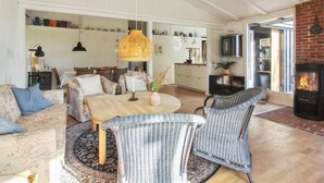 A spacious living room with a high ceiling, a dining area, and a kitchen. - "Tuukka" - 350m from the sea by Interhome (Løkken)