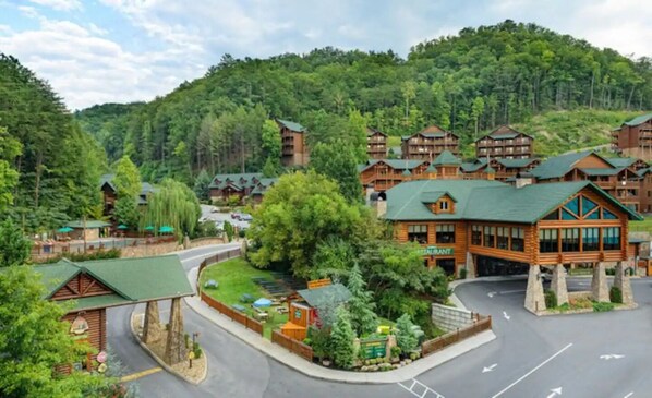 A lodge with multiple wooden buildings, a central restaurant, and a well-maintained surrounding area.