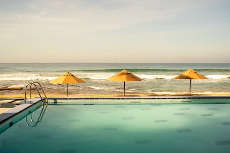 15 outdoor pools, open 9:00 AM to 10:00 PM, pool umbrellas. Neevana Hotel Hikkaduwa